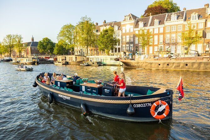 Amsterdam: Guided Open Boat Canal Cruise Including 1 Drink - Who Should Book This Tour?