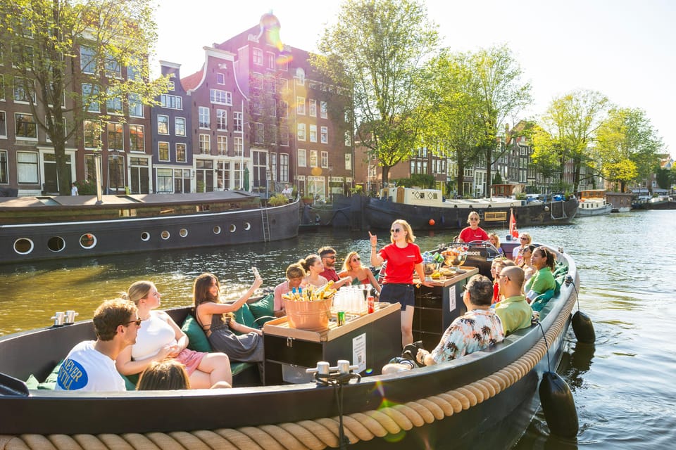 Amsterdam: Guided Open Boat Canal Cruise Including Drink - Practical Details: What to Know