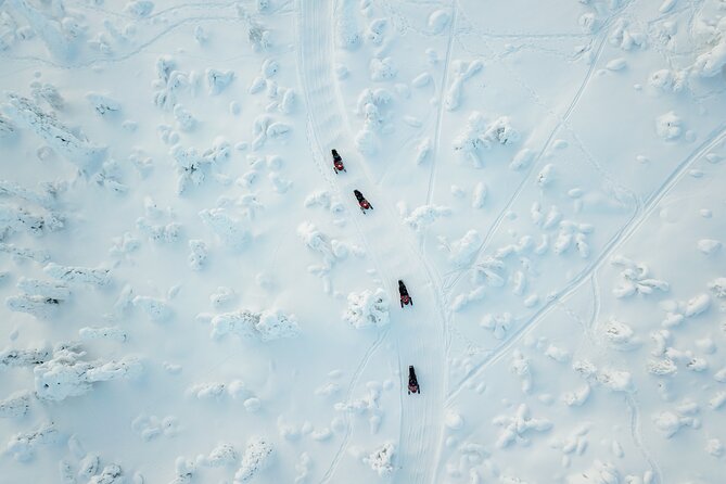 Lappish Lunch Break -Snowmobiling, Ice Fishing and Tasty Food - Thrilling Snowmobiling Adventure