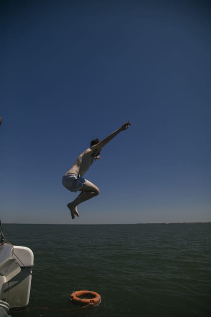 Lisbon: Catamaran Boat Party with Music, Open Bar & Dives - The Sum Up