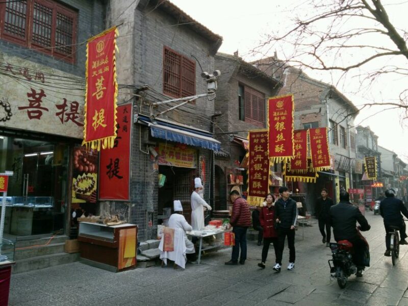 Luoyang Classic Day Tour Longmen Grottoes Old Twon Explore - Itinerary Highlights