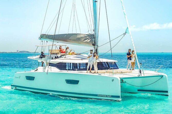 Luxury Catamaran Privilege to Isla Mujeres + Open Bar VIP - A Scenic Journey with a Splash of Adventure