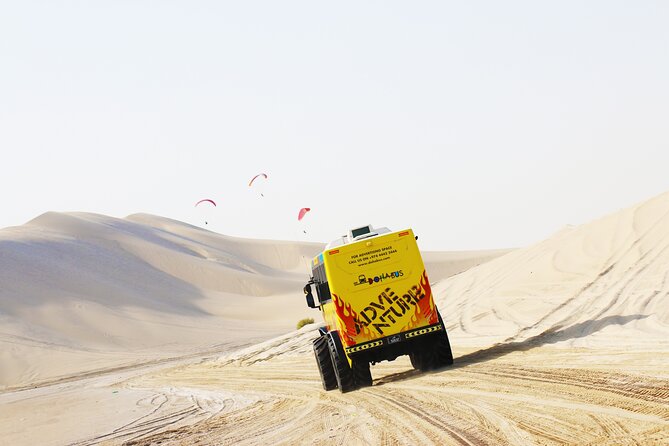 Monster Bus Desert Adventure: Dune Bashing and Sandboarding - Sandboarding Down the Dunes