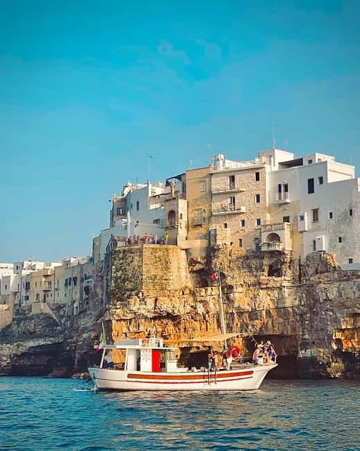 Polignano Monopoli: boat tour on a traditional wooden boat at sunset - The Sum Up
